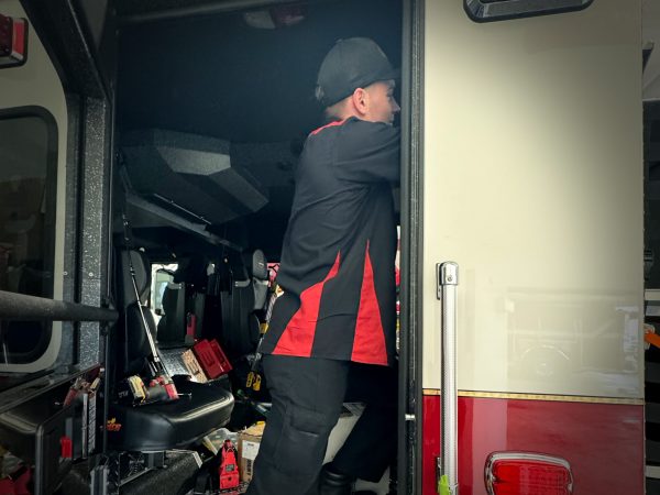 Tech upfitting a fire truck.